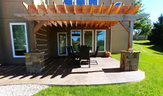 Custom cedar pergola over a stamped concrete patio built by Green Expectations in Kansas City